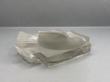 a glass ashtray on a table with a white background