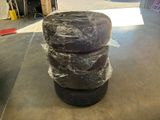 a stack of tires sitting on top of each other in a garage