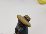 a figurine of a man with a hat on a table