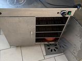 a silver oven with a blue glove on top of it