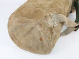 a bag that is sitting on the ground on a white surface