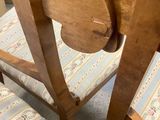 a wooden chair that has a wooden seat and a wooden back rest