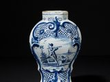 blue and white vase with a man on a boat in the water
