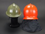 two helmets sitting next to each other on a black surface