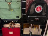 many bags hanging on a rack in a store