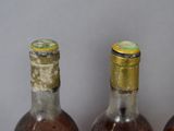 three bottles of wine that are sitting on a table