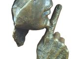 statue of a man with a hat on his head and a finger in his mouth