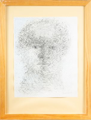une image représentant le dessin d'un visage d'homme dans un cadre en bois