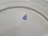 a white plate with a blue design on it