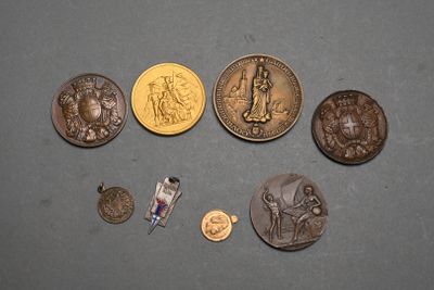 some coins and a pin are sitting on a table