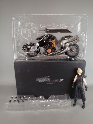 a figurine of a motorcycle and a motorcycle in a display case
