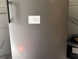 a silver refrigerator sitting on a counter in a kitchen