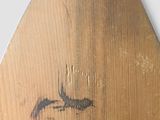 a wooden paddle with a drawing of a dragon on it