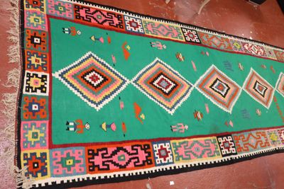 rug on the floor of a house with a green background