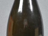 a bottle with a label on it sitting on a table