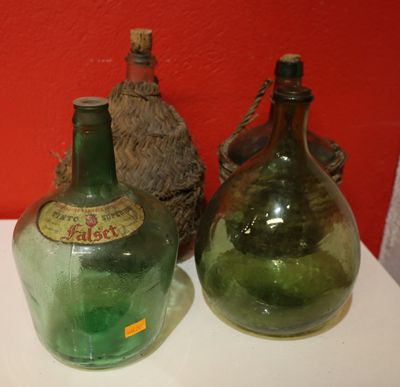 two green glass bottles sitting on a white table