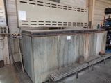 a large metal box sitting in a garage with a bench