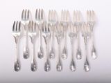 a lot of forks and spoons sitting on a table