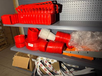 many red plastic cups on a shelf in a room