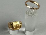 a gold ring sitting on top of a clear glass bottle