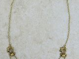 gros plan d'un collier en or sur une surface blanche