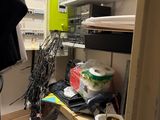 a small room with a lot of clutter on the shelves