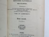 an open book with a black and white image of a plant