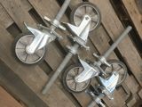 a bunch of metal wheels on a pallet in a warehouse