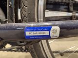 a blue sticker on the back of a bicycle