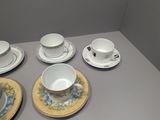 four cups and saucers sitting on a table