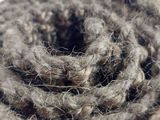 a close up of a rope of yarn on a white surface