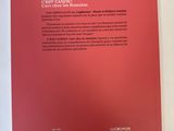 the back cover of a red book on a white surface