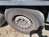 a dirty tire on the side of a truck