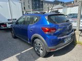 a blue car parked in a parking lot next to a truck