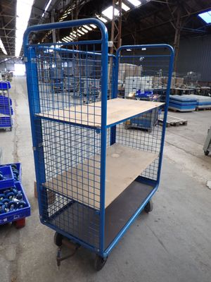 a blue cart with a shelf on it in a warehouse
