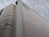 a white refrigerator that is on the side of a building