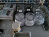 many jars of ice sitting on a table