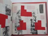an open book with a red and white design on it