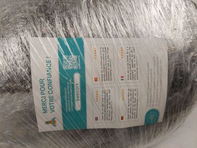 a ball of yarn wrapped in plastic wrap on a table