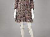 a mannequin dress with fringes and buttons on the shoulders