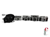 five cameras sitting next to each other on a white surface