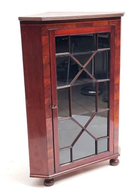 an image of a small wooden cabinet with a glass door