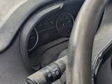 a steering wheel and dashboard of a car on the street