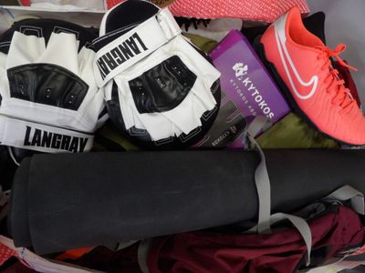 several pairs of tennis shoes are packed in a suitcase