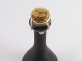 an image of a black bottle with a gold cap on it