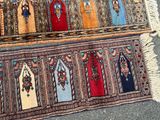 two rugs of different colors and patterns are on the ground