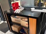a desk with a phone and boxes in front of a window