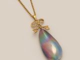 an image of a necklace with a tear shaped pendant on a gold chain