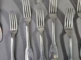 a lot of forks and spoons that are on a table