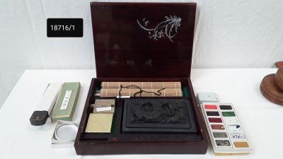 a wooden box with a set of stamps and a brush